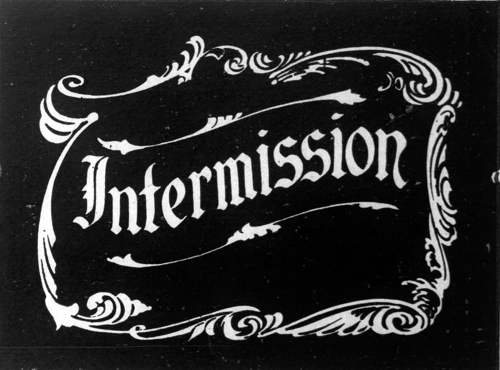 An old-school ornate cinema intermission screen