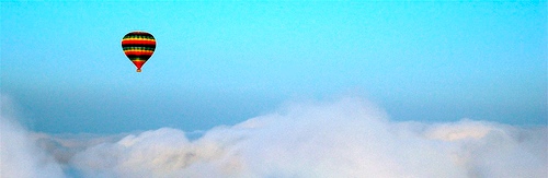 Hot air balloon above clouds