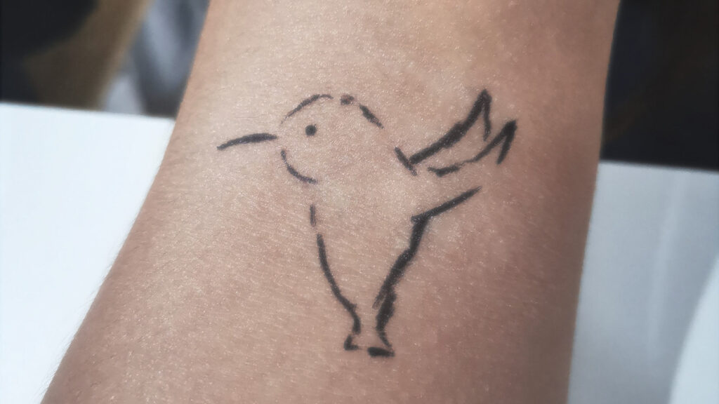 Simple tattoo looking like a hummingbird (or the Twitter logo)