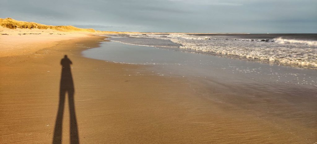 Long shadow on the beach at Druridge Bay, Northumberland
