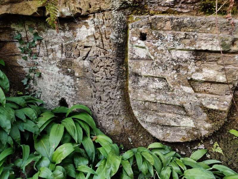 Wall with shield engraved into it, along with some markings and 'AD 1857'