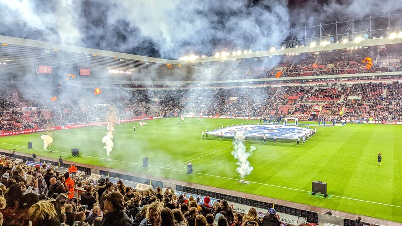 Football stadium with fireworks and flags