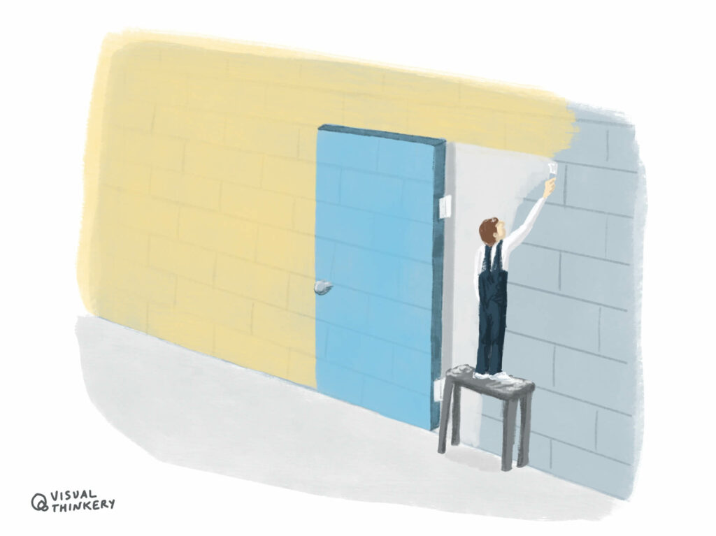 A breeze block wall being painted over. An image of a door is being painted onto the wall as well.